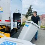mobile shredding service technician loads shred bin