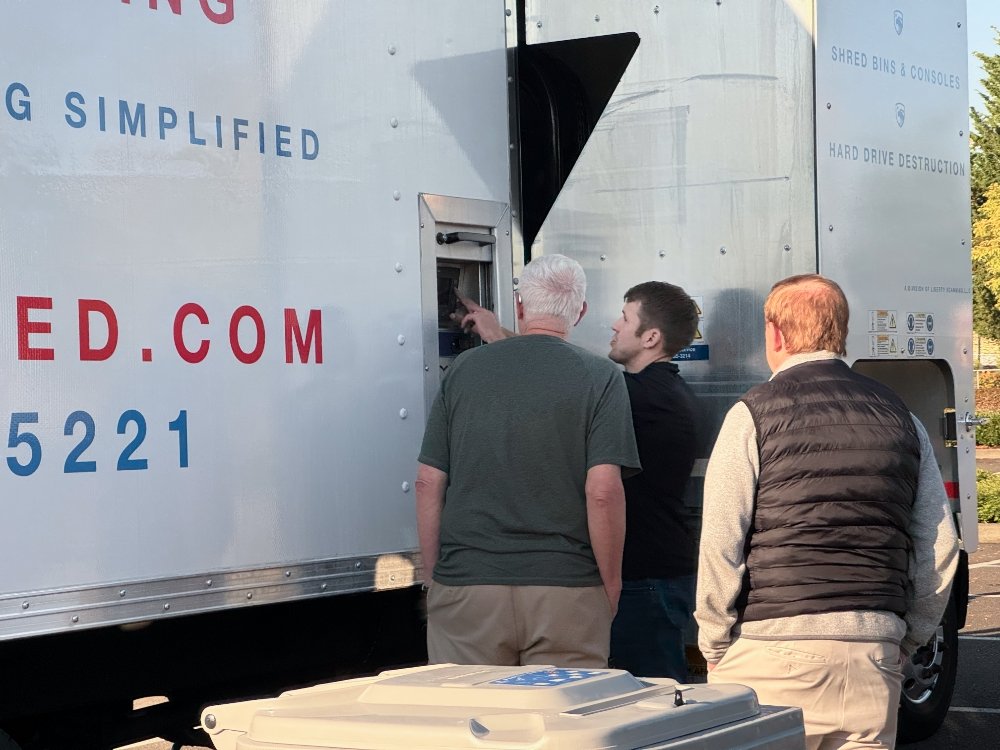 Daniel our shred division lead showing customers how documents get shredded in the shred truck