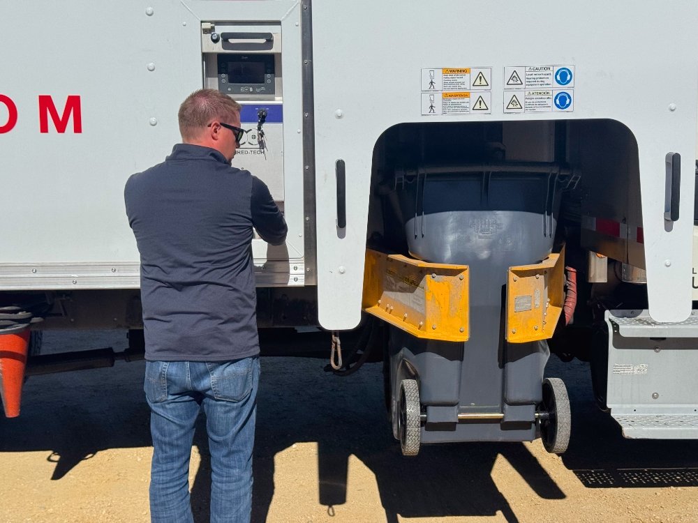 Liberty team member using the truck lift for secure paper collection